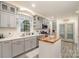 Modern kitchen with grey cabinetry, white countertops, stainless steel appliances, and a butcher block island at 1783 Reepsville Rd, Lincolnton, NC 28092