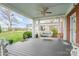 Relax on this covered porch with gray floors, blue ceiling, and a charming wicker swing at 1783 Reepsville Rd, Lincolnton, NC 28092