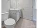 Bathroom showcasing a white toilet, sink, and mirror with great lighting at 2018 Hyacinth Ct, Denver, NC 28037