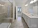 Bathroom featuring double sinks, a large mirror, and a walk-in shower with a built-in bench at 2018 Hyacinth Ct, Denver, NC 28037