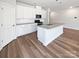 Modern kitchen with white cabinetry, stainless steel appliances, and a spacious center island with seating at 2018 Hyacinth Ct, Denver, NC 28037