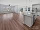 Bright kitchen featuring hardwood floors, white cabinets, stainless steel appliances, and a center island at 2018 Hyacinth Ct, Denver, NC 28037