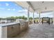An outdoor kitchen area featuring a built-in grill and plenty of counter space and stamped concrete flooring at 2018 Mantle Ridge Dr, Indian Trail, NC 28079