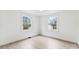 Bright bedroom with hardwood floors and two windows allowing ample natural light at 212 Sloan St, Belmont, NC 28012