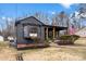 Charming single-story home with a covered front porch, American flag, and tidy yard with landscaping at 212 Sloan St, Belmont, NC 28012
