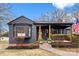 Charming single-story home featuring a covered front porch, brick accents, and neatly trimmed landscaping at 212 Sloan St, Belmont, NC 28012