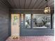 Inviting covered front porch with elegant lighting, decorative wreath, and patterned tile floor at 212 Sloan St, Belmont, NC 28012
