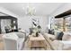 Beautiful living room with modern chandelier, large windows, and neutral tones to create a relaxing atmosphere at 212 Sloan St, Belmont, NC 28012