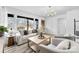 Sun-filled living room featuring stylish decor, contemporary lighting, and a comfortable seating arrangement at 212 Sloan St, Belmont, NC 28012
