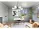 Bright home office featuring a modern chandelier, white desk with gold accents, and neutral tones at 212 Sloan St, Belmont, NC 28012