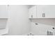 Bright laundry room with white cabinets and black hardware at 228 Miramar Dr, York, SC 29745