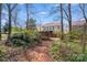 Backyard with lush vegetation, path, and structure, offering a private and serene retreat at 2324 Chestnut Ln, Matthews, NC 28104