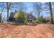 Expansive backyard with mature trees and lush landscaping surrounding a well-maintained home at 2324 Chestnut Ln, Matthews, NC 28104