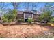 Lush backyard featuring mature trees, a manicured lawn, and an inviting outdoor space at 2324 Chestnut Ln, Matthews, NC 28104