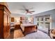 Charming bedroom with wood floors, ceiling fan, natural light, and unique bird-themed artwork at 2324 Chestnut Ln, Matthews, NC 28104