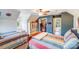 Bright bedroom with colorful bedding, closet, ceiling fan, and convenient built-in shelving at 2324 Chestnut Ln, Matthews, NC 28104