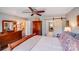 Inviting bedroom featuring ceiling fan, wood furniture, and sliding barn door to the bathroom at 2324 Chestnut Ln, Matthews, NC 28104