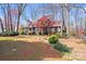 Charming Tudor-style home with a well-manicured front yard and mature landscaping at 2324 Chestnut Ln, Matthews, NC 28104