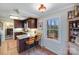 Well-lit kitchen with granite countertops, dark cabinetry, and a breakfast bar for casual dining at 2324 Chestnut Ln, Matthews, NC 28104
