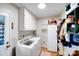 Functional laundry room with washer, dryer, storage cabinets, and ample space for sorting and folding clothes at 2324 Chestnut Ln, Matthews, NC 28104