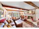 Bright living room with exposed wood beams, fireplace, and large windows at 2324 Chestnut Ln, Matthews, NC 28104
