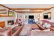 Cozy living room featuring a fireplace, exposed wood beams, and comfortable leather seating at 2324 Chestnut Ln, Matthews, NC 28104