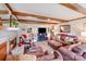 Comfortable living room featuring a fireplace, exposed beams, and open view to the dining area at 2324 Chestnut Ln, Matthews, NC 28104