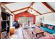 Bright living area featuring a vaulted ceiling with wooden beams, large windows, and comfortable seating arrangement at 2324 Chestnut Ln, Matthews, NC 28104