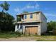 Two-story home featuring a covered upper deck and a gray exterior and a two-car garage at 2725 Celia Ave, Charlotte, NC 28216