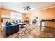 Bright living room with hardwood floors, ceiling fan, and a built-in wet bar area at 3839 Mountain Cove Dr, Charlotte, NC 28216