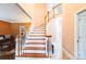 Grand staircase with white spindles and wooden handrails, leading to the upper level at 3839 Mountain Cove Dr, Charlotte, NC 28216