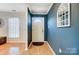 Inviting foyer featuring elegant blue walls, hardwood floors, and a decorative window, creating a warm entrance at 3842 Saxonbury Way, Charlotte, NC 28269