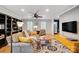 Bright and inviting living room featuring hardwood floors, a ceiling fan, and comfortable seating, perfect for relaxation at 3842 Saxonbury Way, Charlotte, NC 28269