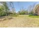 Expansive backyard view with lush lawn, outbuilding, and mature trees at 410 E Arch St, Lancaster, SC 29720