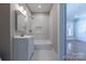 Bathroom with vanity, shower over tub, and a white marble tile surround at 410 E Arch St, Lancaster, SC 29720