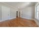 Bright bedroom featuring hardwood floors, neutral walls, and classic trim details at 410 E Arch St, Lancaster, SC 29720