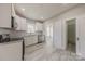Bright kitchen features white cabinets, granite countertops, stainless appliances, and pantry at 410 E Arch St, Lancaster, SC 29720