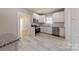 Bright kitchen features white cabinets, stainless appliances, and granite countertops at 410 E Arch St, Lancaster, SC 29720