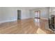 Sun-drenched living room highlighting hardwood floors, with views of built-in shelving and French doors at 410 E Arch St, Lancaster, SC 29720