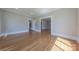 A spacious living room with hardwood floors, highlighted by a doorway leading to other rooms and classic trim at 410 E Arch St, Lancaster, SC 29720