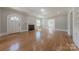 Open living area with hardwood floors, a decorative fireplace, and an arched doorway enhancing the home's character at 410 E Arch St, Lancaster, SC 29720