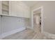 Functional mud room featuring white cabinetry, updated plank flooring, and convenient access to other areas at 410 E Arch St, Lancaster, SC 29720