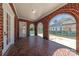 Brick covered outdoor porch with brick arches, white trim and tile floor at 410 E Arch St, Lancaster, SC 29720