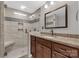 Modern bathroom featuring a glass enclosed shower with built in bench and brown vanity with granite countertops at 4604 Karwood Dr, Rock Hill, SC 29732