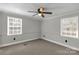 Bright bedroom featuring neutral carpet, paneled walls, and a window at 4604 Karwood Dr, Rock Hill, SC 29732
