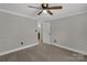 Spacious bedroom featuring neutral carpeting, ceiling fan, and paneled walls at 4604 Karwood Dr, Rock Hill, SC 29732