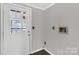 Well-lit mud room with paneled walls featuring a door to the backyard and washer and dryer hookups at 4604 Karwood Dr, Rock Hill, SC 29732