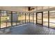 Enclosed screened porch with wood flooring and a ceiling fan overlooking the backyard at 4604 Karwood Dr, Rock Hill, SC 29732