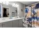 Bathroom with double sinks, a toilet with colorful accents, and a shower with a unique curtain at 468 Wilhelm Ne Pl, Concord, NC 28025