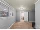 Carpeted bedroom with ample lighting, an adjacent room and large windows at 468 Wilhelm Ne Pl, Concord, NC 28025